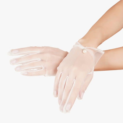 Detail shot of Totka pearl embellished tulle gloves - sheer hand accessories for Indian brides.