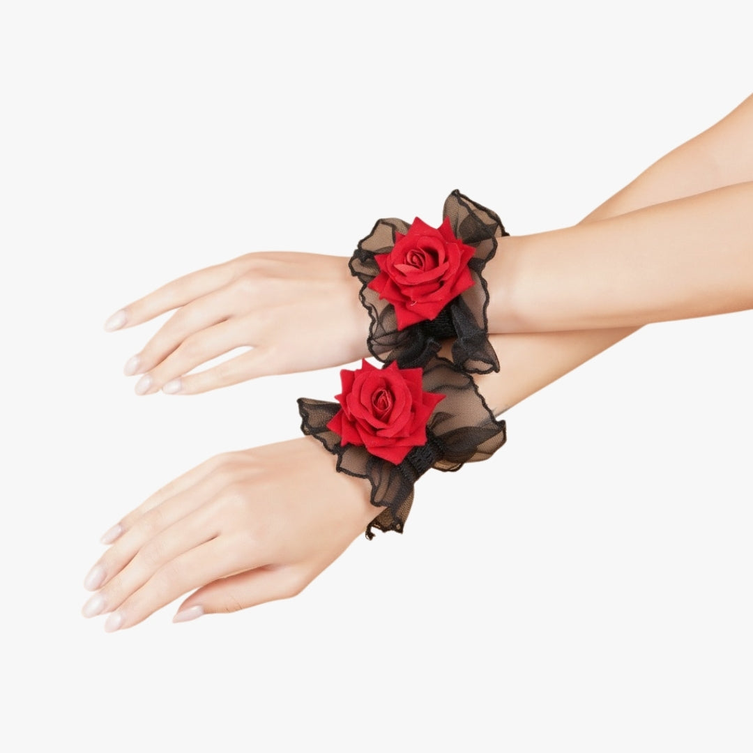 lose-up of a pair of Totka red rose wristlets featuring black mesh ruffles; ideal floral jewelry for Haldi and Mehendi functions.