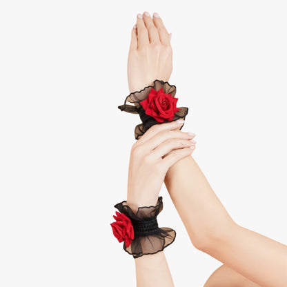 Totka black ruffled floral wristbands with red roses displayed on raised arms; aesthetic hand flower bracelet for prom and formal events.
